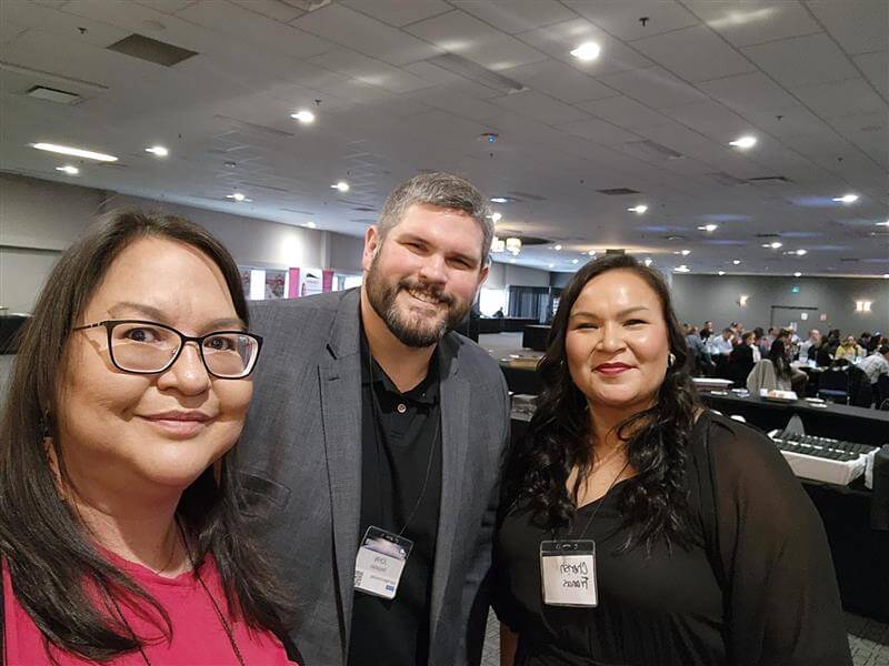 DIrector of Indigenous Relations Trista Pewapisconias poses for a selfie with John Desjarlais and Cherish Francis